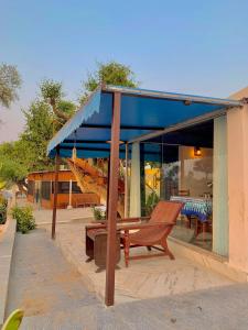 a wooden bench sitting in front of a building at Shivgarh Sustainable Resort in Dādu