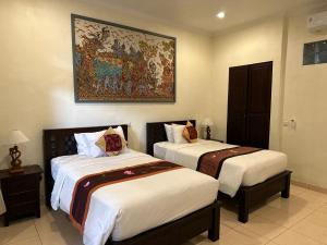 Postel nebo postele na pokoji v ubytování Brata Inn Ubud