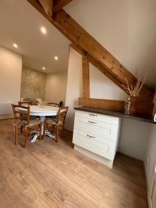 a dining room with a white table and chairs at Gite de l'Ormes Magnolia in Nanteau-sur-Essonnes +5 photos
