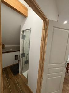 a hallway with a door and a mirror at Gite de l'Ormes Magnolia in Nanteau-sur-Essonnes