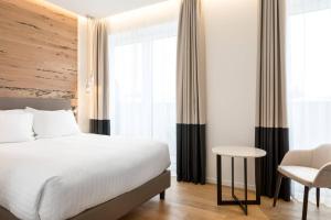 a hotel room with a bed and a chair at AC Hotel Venezia by Marriott in Venice