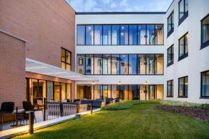 an exterior view of a building with a yard at AC Hotel Venezia by Marriott in Venice