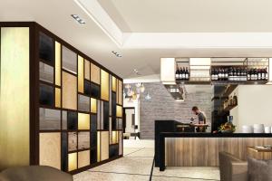 a man standing at a bar in a restaurant at AC Hotel Venezia by Marriott in Venice +37 photos