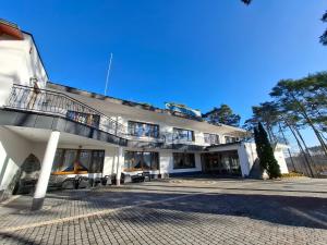 a white building with a balcony on top of it at Wodnik Turawa in Turawa