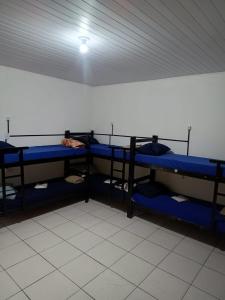 a room with blue bunk beds in a room at O Hostel GRU SP - Unidade Aeroporto Guarulhos - 5 Minutos de Distancia in Guarulhos