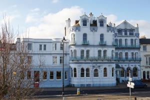 a large white building with a lot of windows at Royal Esplanade Hotel in Ryde
