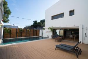 a house with a swimming pool and a patio at Amuse Athens Villa in Vari