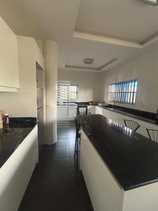 a kitchen with black counter tops in a room at Three bedroom luxurious house "Owusu- ansah transformer" in Pantang