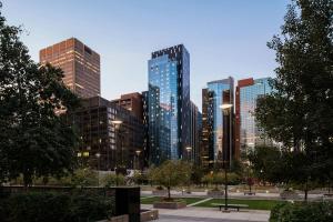 a city skyline with tall buildings in a park at The Dorian, Autograph Collection in Calgary