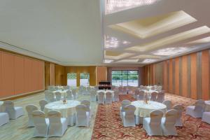 a banquet hall with tables and chairs and a piano at Courtyard by Marriott Madurai in Madurai +60 photos