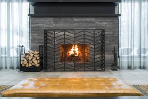 a fireplace with a fire in it at Kananaskis Mountain Lodge, Autograph Collection in Kananaskis Village
