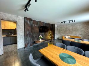 a living room with a wooden table and chairs at Chokolate house in Bukovel