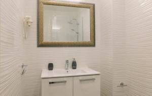 a white bathroom with a sink and a mirror at Villa Zora with hot tub, Mošćenička Draga - Obrš in Kraj +29 photos