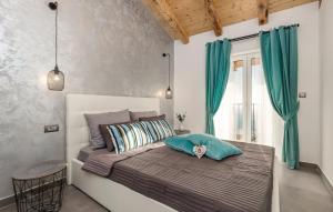 a bedroom with a large bed with blue curtains at Villa Zora with hot tub, Mošćenička Draga - Obrš in Kraj