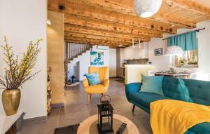 a living room with a blue couch and a table at Villa Zora with hot tub, Mošćenička Draga - Obrš in Kraj