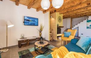 a living room with a blue couch and a table at Villa Zora with hot tub, Mošćenička Draga - Obrš in Kraj