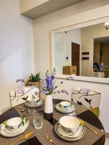a dining room table with plates and dishes on it at Bangs Hive at Palladium Megaworld in Iloilo City +4 photos