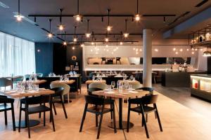 a restaurant with tables and chairs in a room at Renaissance Warsaw Airport Hotel in Warsaw