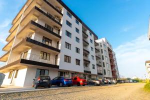 a group of cars parked in front of a building at By the Sea Plusoi Apartment in Năvodari