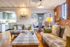 a living room with a couch and a table at The Old Smithy by Big Skies Cottages in Little Walsingham
