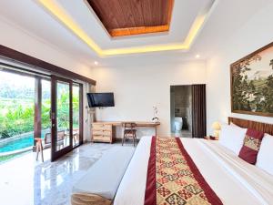 a bedroom with a large bed and a tv at Arvanya Villa Ubud in Tegalalang