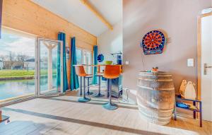 a room with a table and chairs and a barrel at Awesome Home In Milly-Sur-Thérain in Milly-sur-Thérain