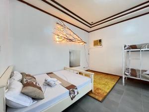 a bedroom with a bed and a bunk bed at R&J homestay in Tina-an