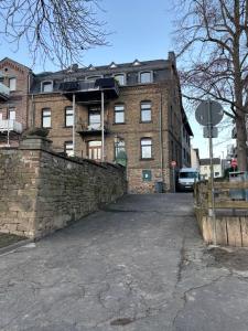 a large brick building with a stone wall at Lahnblick Deluxe in Lahnstein