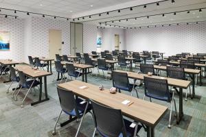 a classroom with rows of tables and chairs at Aloft Louisville Downtown in Louisville