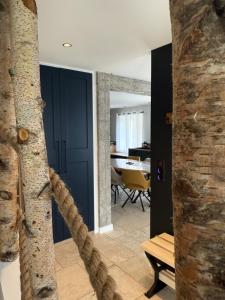 a living room with a tree and a table at Logement du 162 in Anould