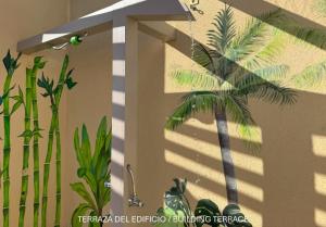 a shadow of a palm tree on a wall at Apartamentos Ohana - Edificio Tonillo in Los Cristianos