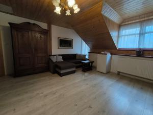 a living room with a couch and a table at Penzion Pod Chřiby in Zdounky