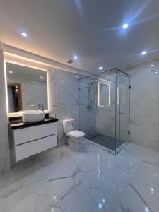 a bathroom with a shower and a sink and a toilet at Villa familiale avec piscine in Agadir +16 photos