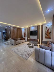 a large living room with couches and a table at Villa familiale avec piscine in Agadir