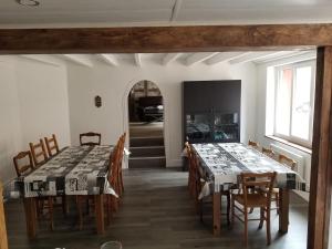 a dining room with two tables and chairs and a window at Grand Gîte grande capacité dans l'Allier in Loddes