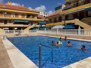 a group of people swimming in a swimming pool at Vinamar Alena in La Mata