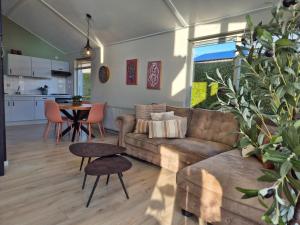 a living room with a couch and a table at De Vos in Tzummarum