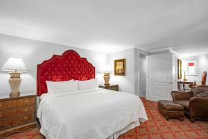 a bedroom with a large bed with a red headboard at Casa Monica Resort & Spa, Autograph Collection in Saint Augustine +94 photos