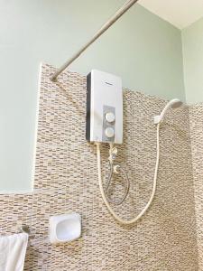 a shower in the corner of a bathroom at ZK Homestay in Puerto Princesa City