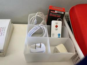 a box with a remote control and other items on a table at ZK Homestay in Puerto Princesa City