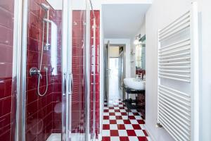 a bathroom with a red tiled shower and a sink at Old Town, near Ponte Vecchio in Florence