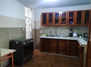 a kitchen with a sink and a dishwasher at no disponibl in Trujillo