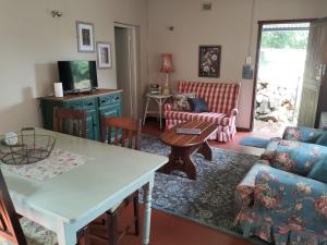 a living room with a couch and a table at Primula Cottage at Hillhouse in Hilton