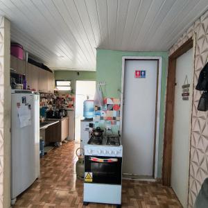 a kitchen with a stove and a refrigerator at Casa em Manaus in Manaus
