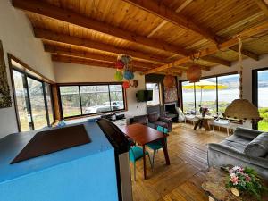a kitchen and living room with a table and chairs at Villa Vista in Guatavita