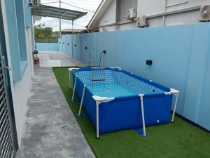 a blue batting cage on the side of a building at Biru Home PD Famili Selesa Suppa Pool & Aircond in Port Dickson
