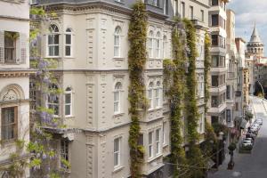 an apartment building with ivy growing on it at Adahan DeCamondo Pera, Autograph Collection in Istanbul