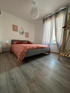 a bedroom with a bed and a chandelier at Chez Brunella Reims centre avec parking in Reims