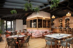 a restaurant with tables and chairs and plants at Adahan DeCamondo Pera, Autograph Collection in Istanbul