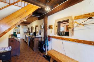 a large kitchen with a counter and a counter top at Haugstetter Schwarzwaldhaus in Neubulach